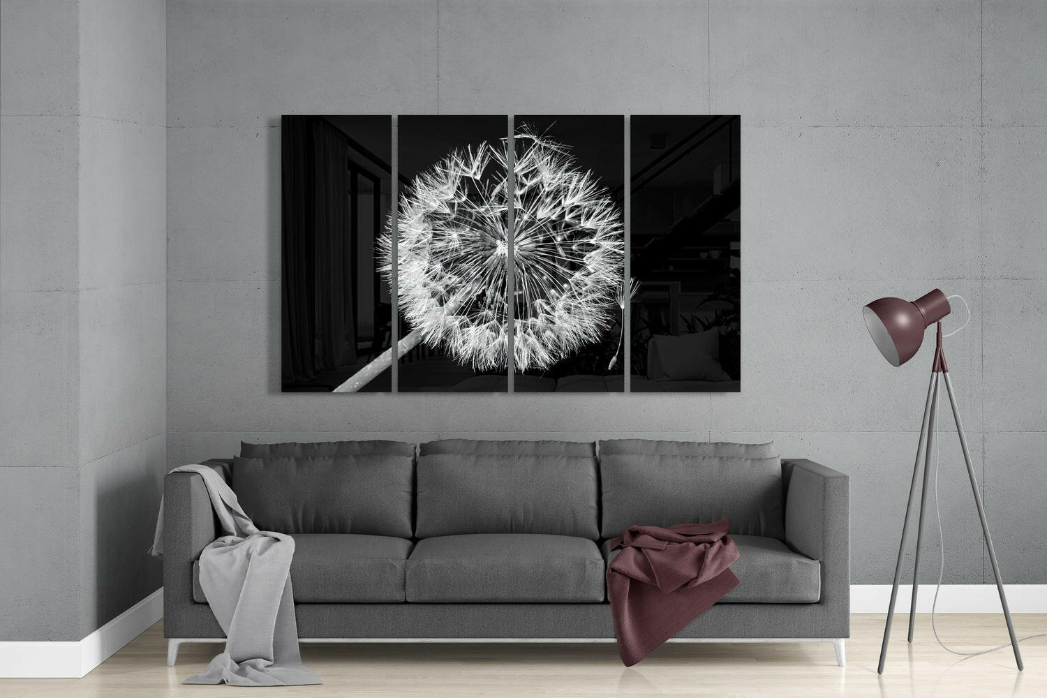 Modern living room interior with gray sofa displaying four-panel black and white dandelion artwork above it.