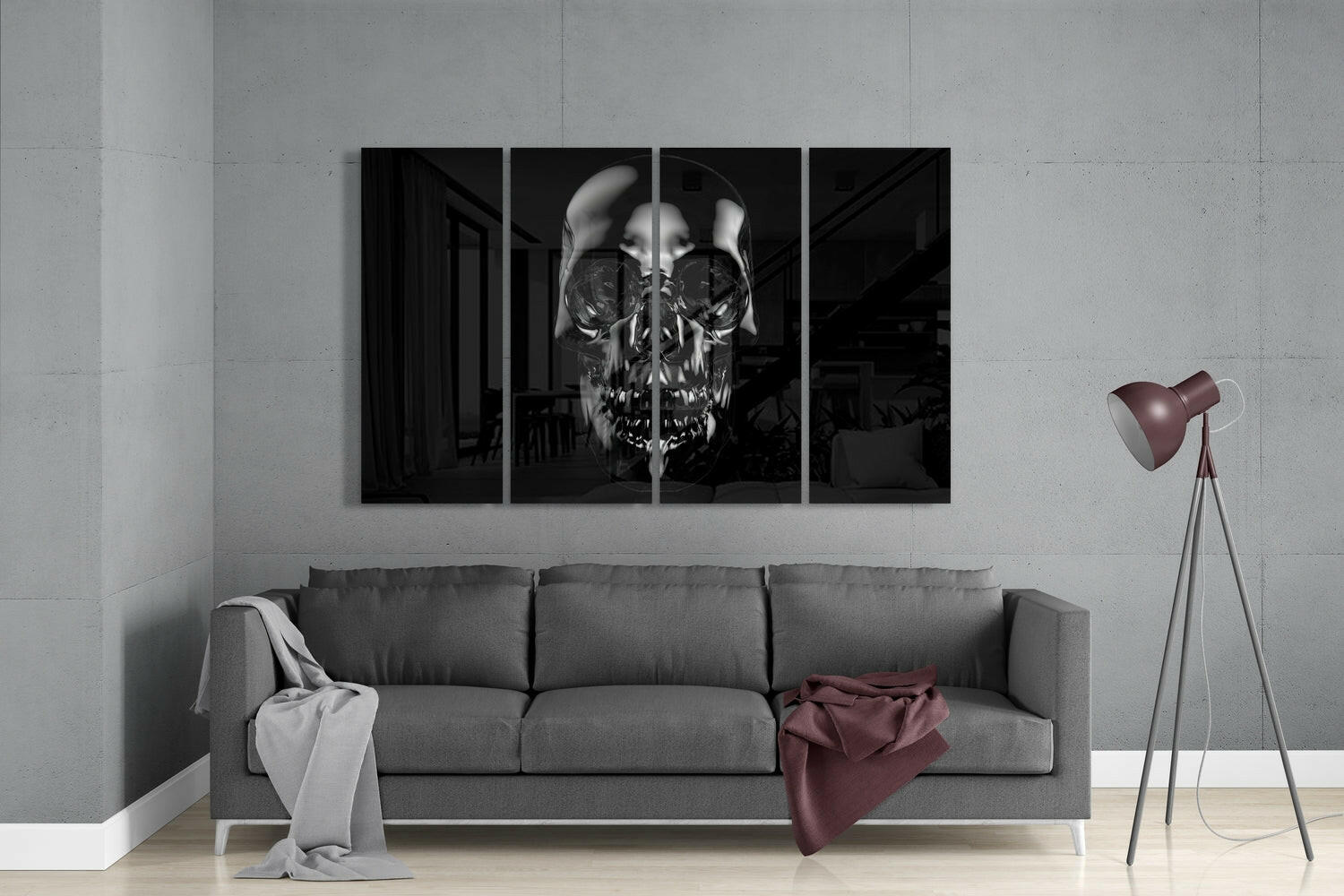 Four-panel black and white skull artwork displayed above gray sofa in modern living room with tripod lamp.