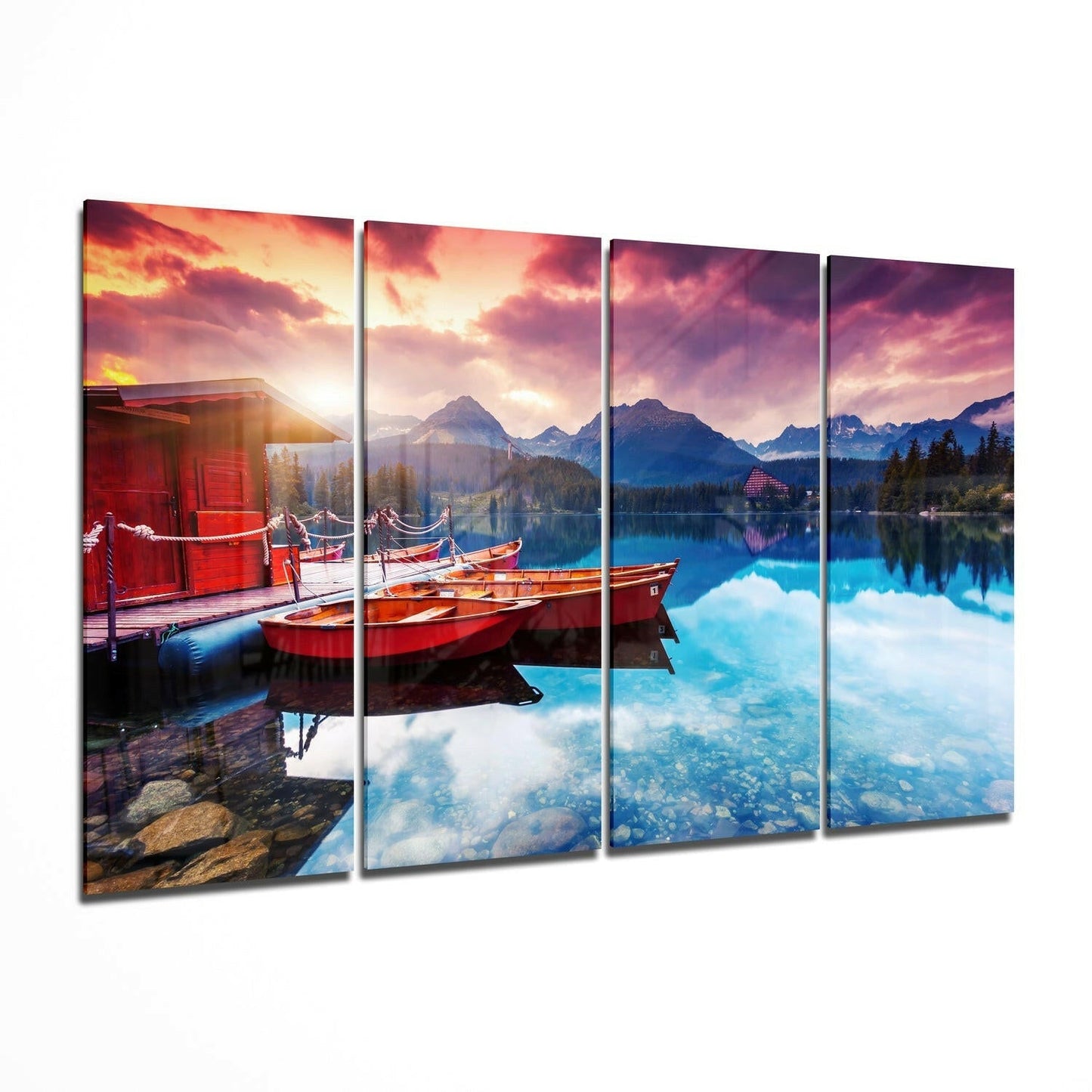 Four-panel glass wall art depicting red boats moored at a lakeside cabin at sunset with mountains and reflective water.