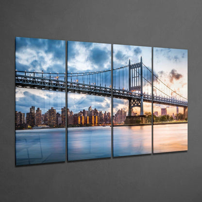 Four-panel glass wall art displaying the Queensboro Bridge and Manhattan skyline at sunset, with warm golden and blue tones reflected in the East River.