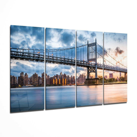 Four-panel glass wall art displaying the Queensboro Bridge spanning the East River with Manhattan skyline at sunset, featuring warm golden and blue tones.
