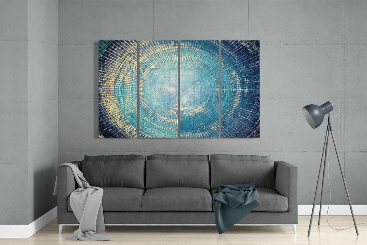 Modern living room with turquoise and gold concentric circle glass wall art displayed above gray sofa.