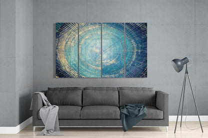 Modern living room with turquoise and gold concentric circle glass wall art displayed above gray sofa.