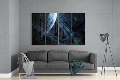 Modern living room with gray sofa displaying four-panel glass wall art featuring blue planet and space rings above furniture.