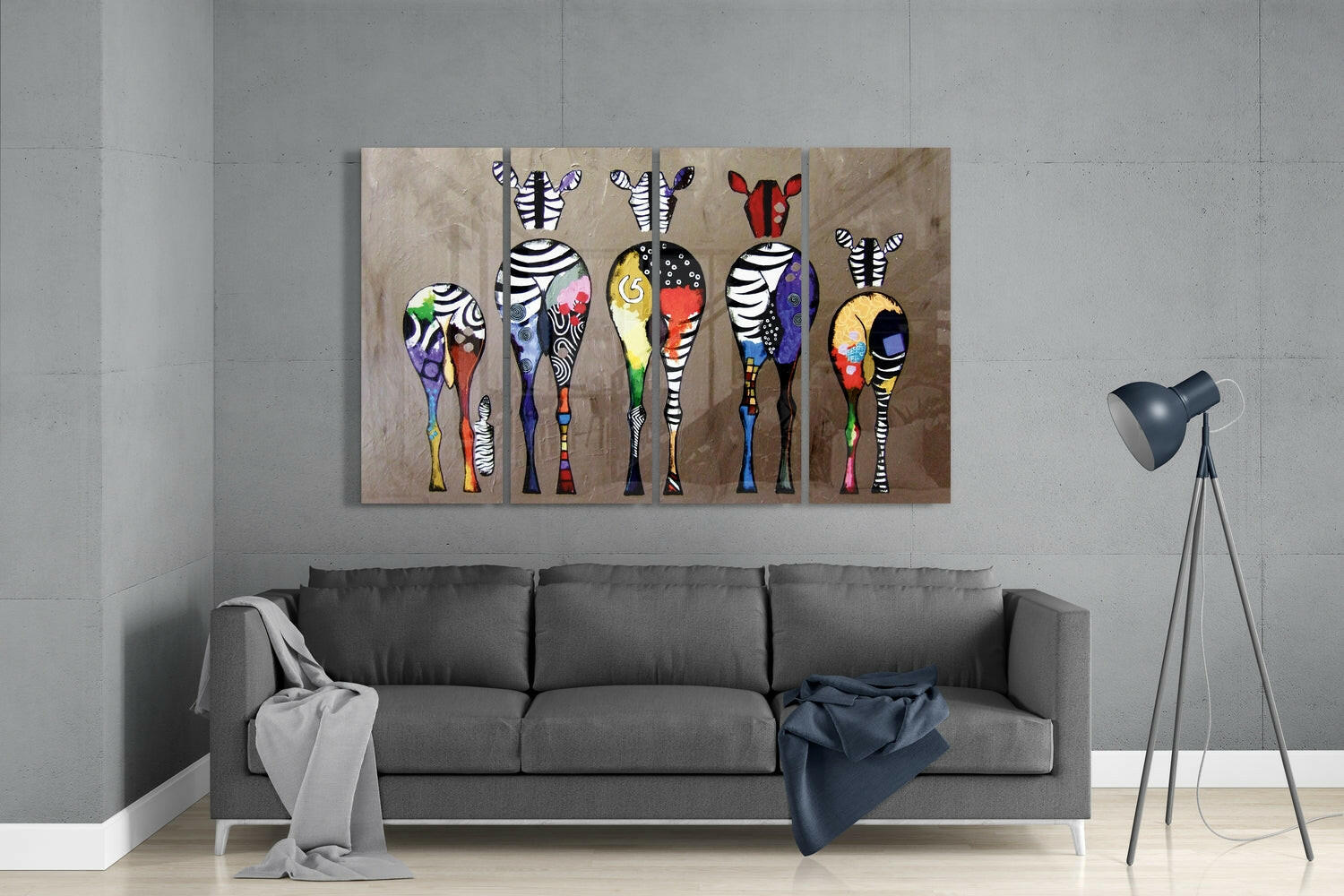 Colorful zebra wall art displayed above gray sofa in modern living room with tripod lamp.