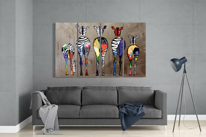 Colorful zebra wall art displayed above gray sofa in modern living room with tripod lamp.