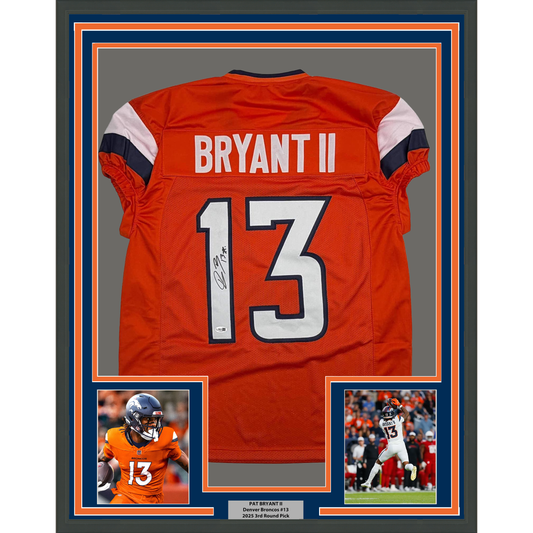 Signed red Denver Broncos #13 jersey displayed in frame with player photos and nameplate below.