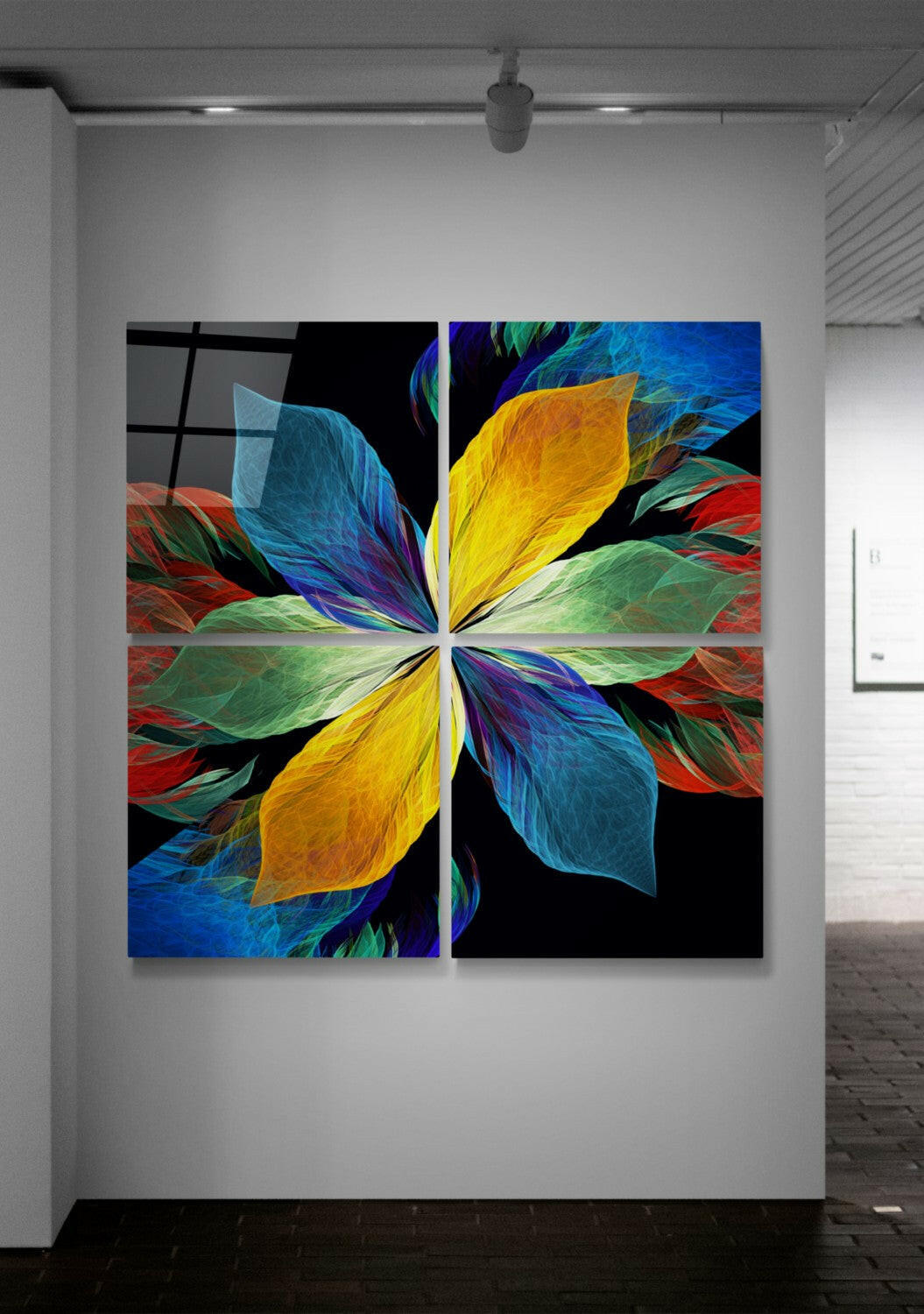 Four-panel glass wall art displaying a symmetrical flower design with vibrant yellow, blue, green, and red petals against black background, installed in gallery space.