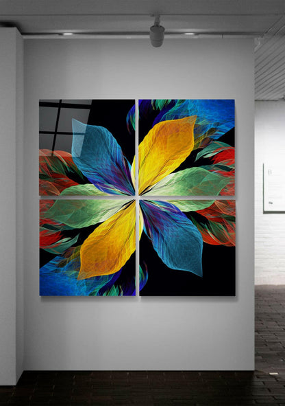 Four-panel glass wall art displaying a symmetrical flower design with vibrant yellow, blue, green, and red petals against black background, installed in gallery space.
