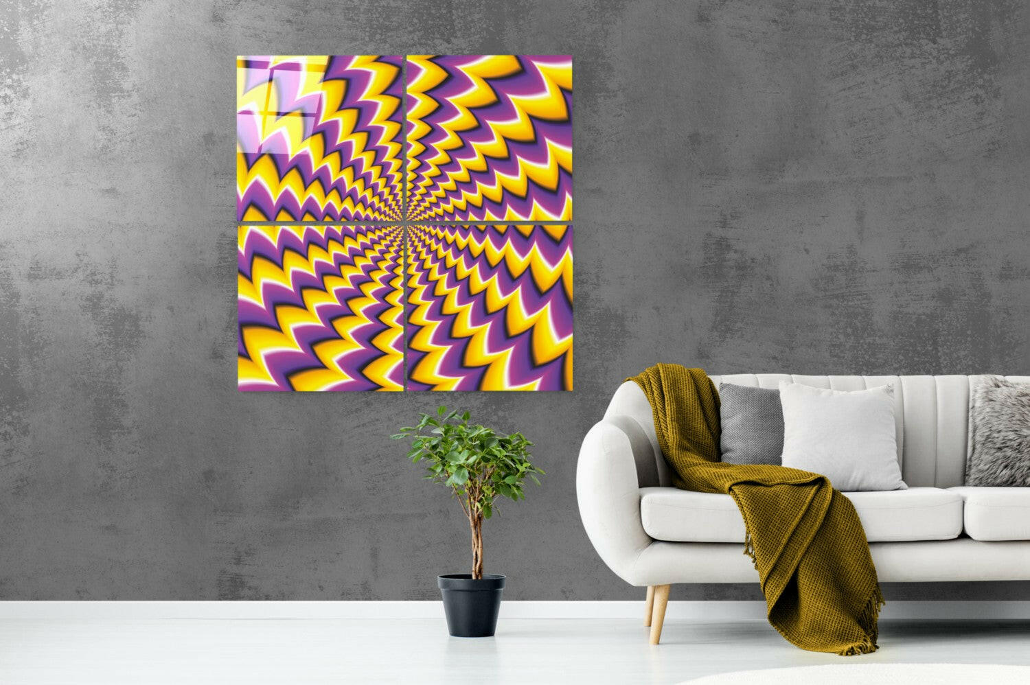 Yellow and purple radiating zigzag pattern glass art displayed on gray wall above white sofa with plant and gold blanket.