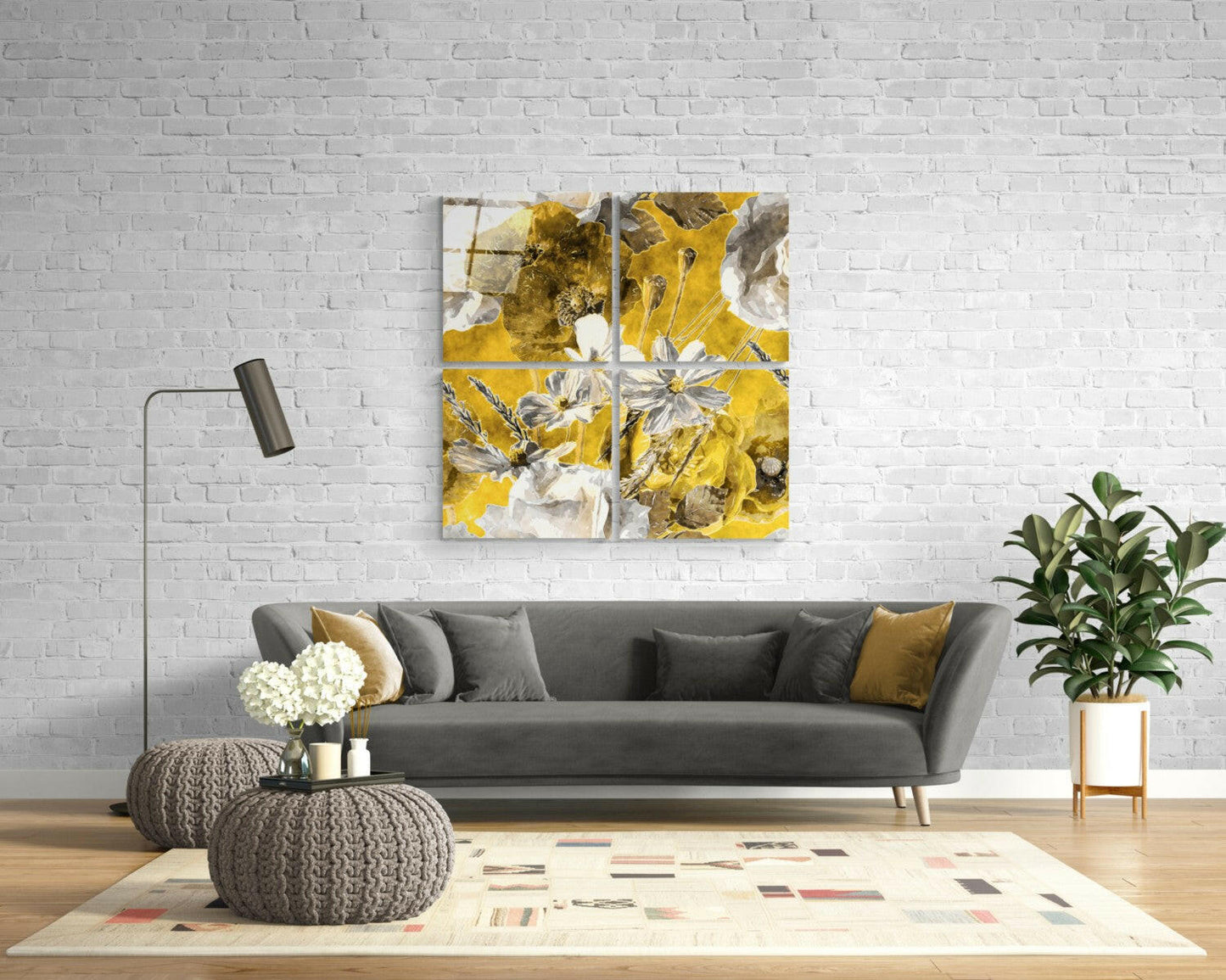 Four-panel yellow and white floral glass wall art displayed above gray sofa in modern living room setting.