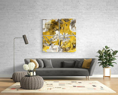 Four-panel yellow and white floral glass wall art displayed above gray sofa in modern living room setting.