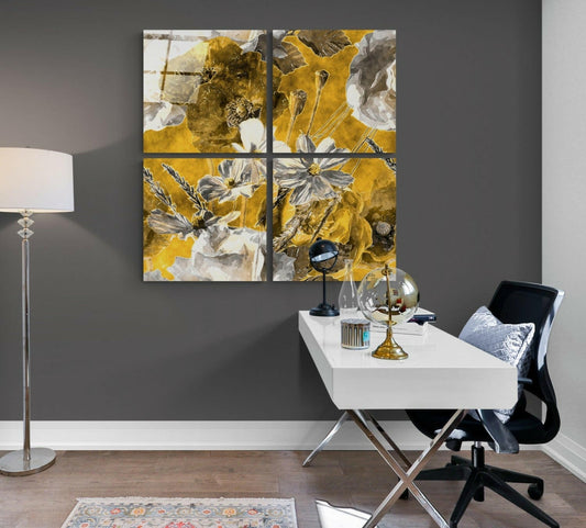 Four-panel glass wall art with yellow and white abstract floral designs displayed above a white desk in a modern office setting.
