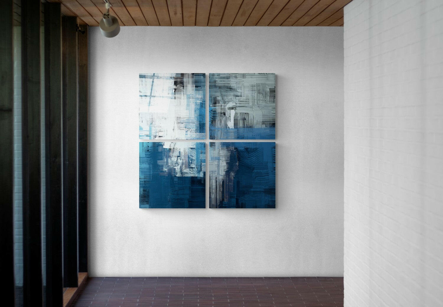 Four-panel blue and white abstract glass artwork mounted on white wall in modern interior space with wooden ceiling.