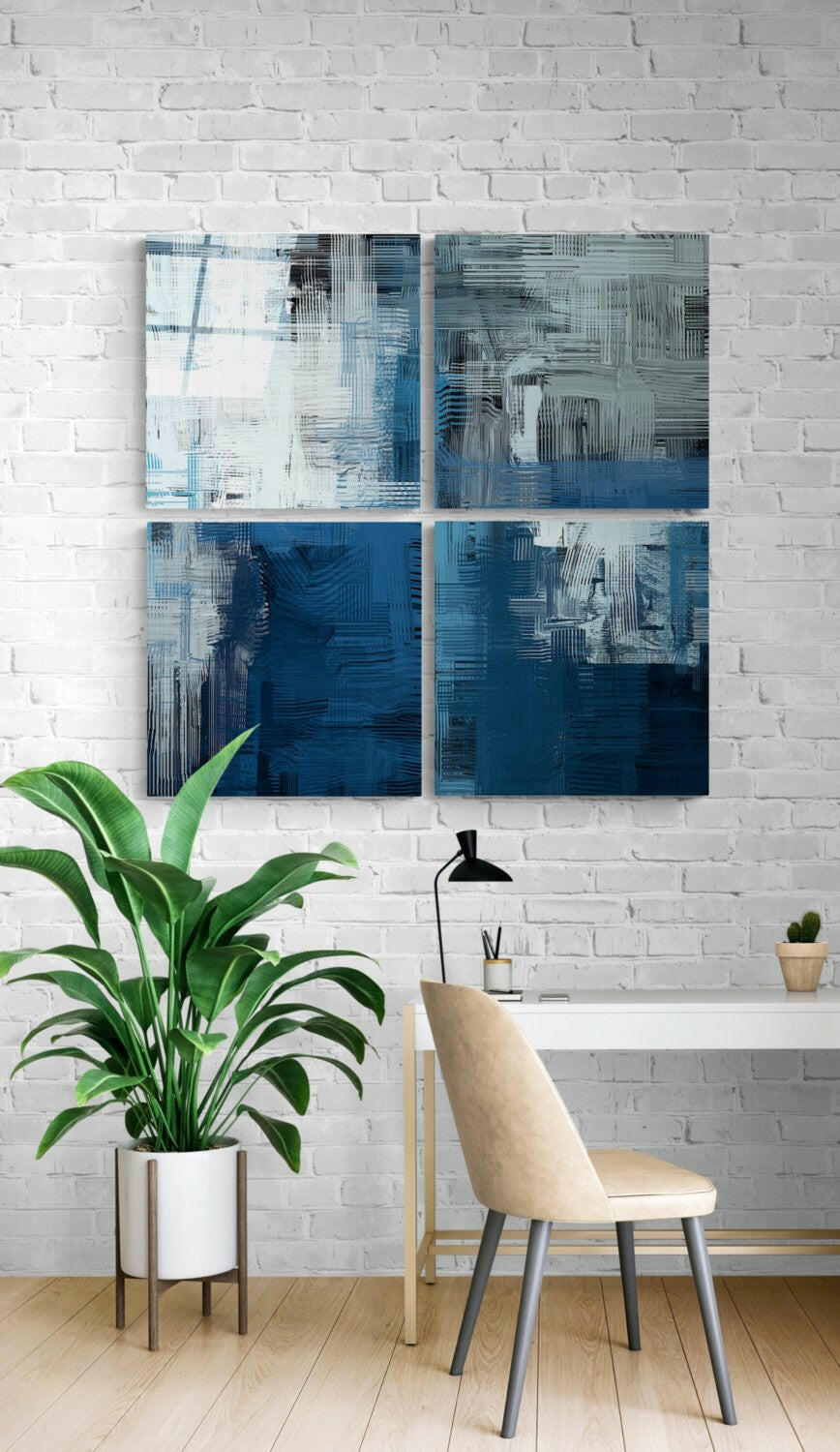 Four-panel blue and white abstract glass wall art installation above a desk with a potted plant and beige chair.