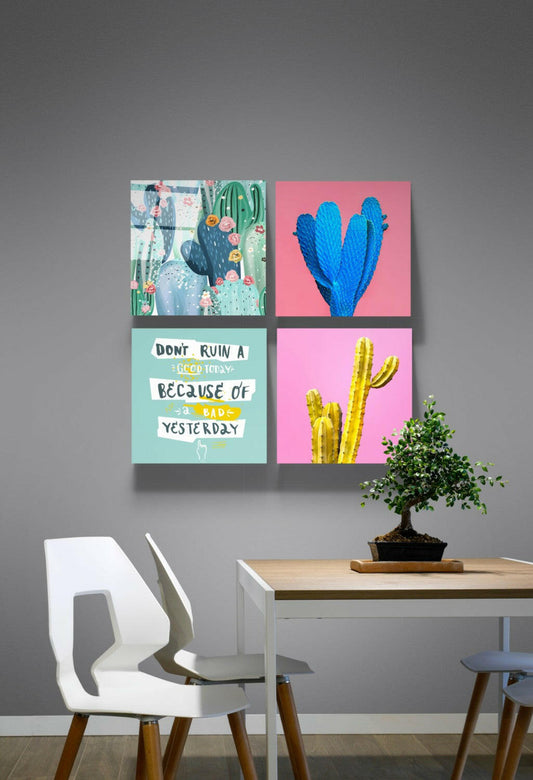 Four-panel glass wall art displaying colorful cacti illustrations in pink, blue, and yellow with motivational text on mint background, installed above desk.