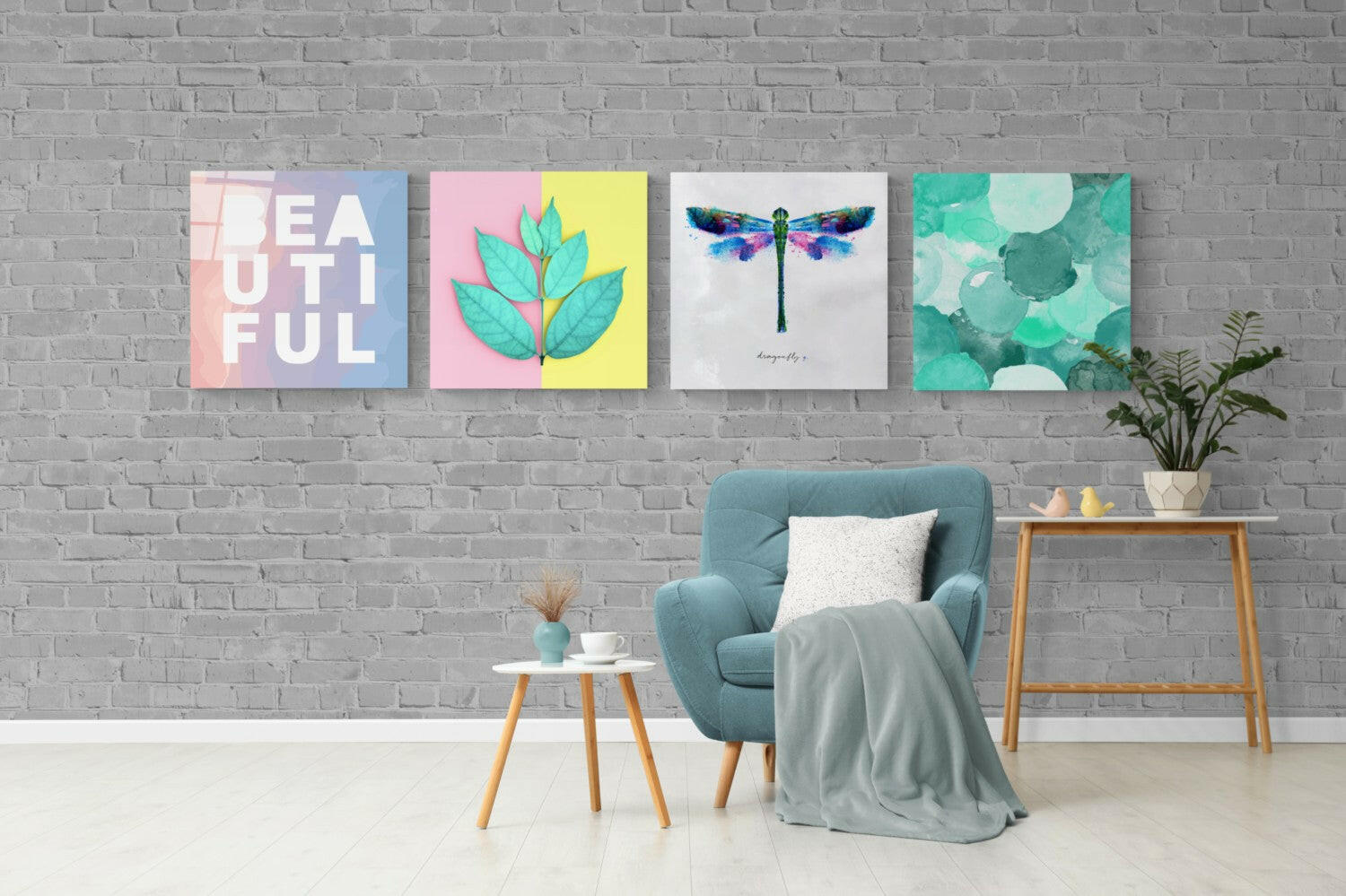 Four glass wall art panels in pastel colors displaying "beautiful," botanical leaves, watercolor dragonfly, and abstract circles hung above teal armchair in modern living room.