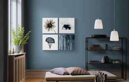 Four-panel glass wall art mounted above a bed displaying a flower, elephant, hot air balloon with text, and wooden texture in a blue bedroom.
