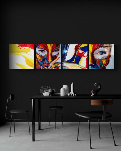 Modern dining room with black table and chairs beneath four vibrant multicolored glass panels featuring painted faces and abstract designs.