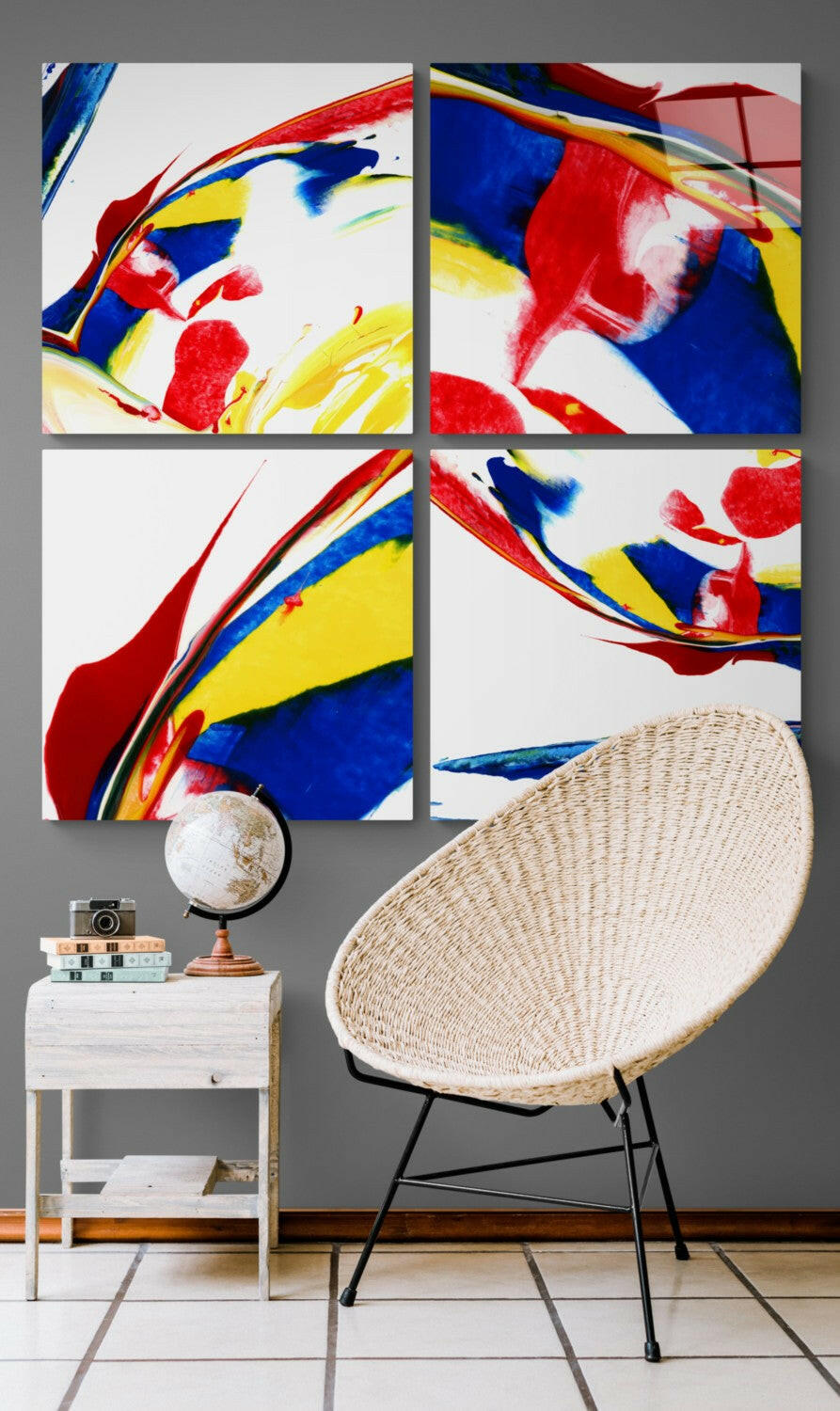 Modern interior setting with four-panel colorful glass wall art above white nightstand, globe, camera, and woven chair with metal legs.