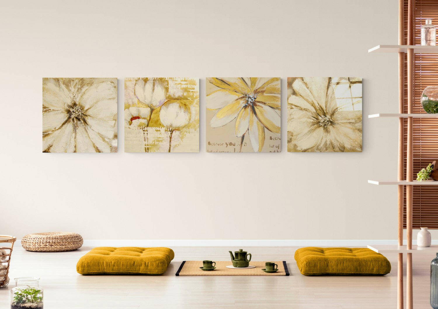 Four cream and yellow flower canvas artworks hanging horizontally above a white bench with gold cushions and tea service.