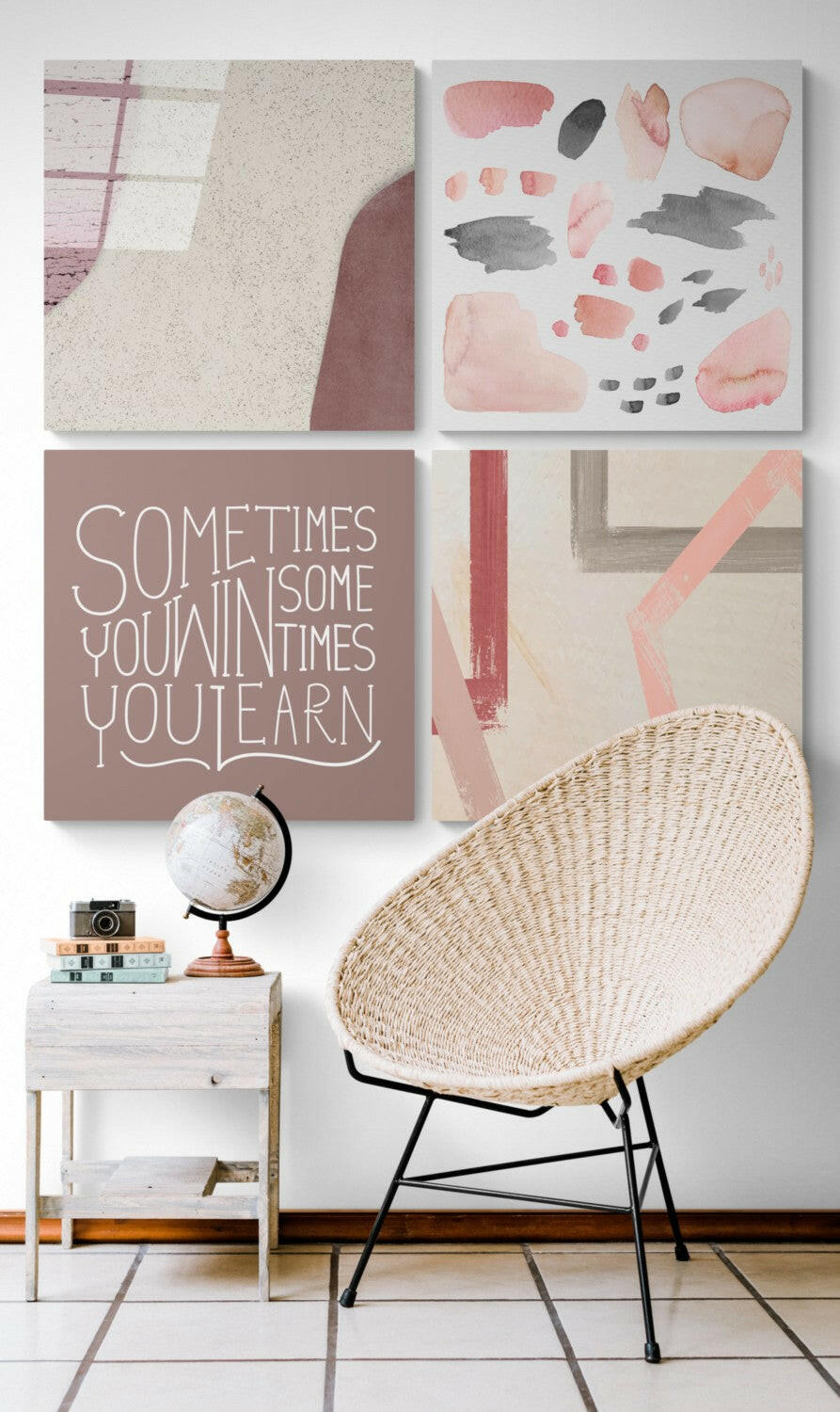 Modern bedroom wall display with four framed artworks in pink, beige, and gray tones above a woven chair and white nightstand with globe.