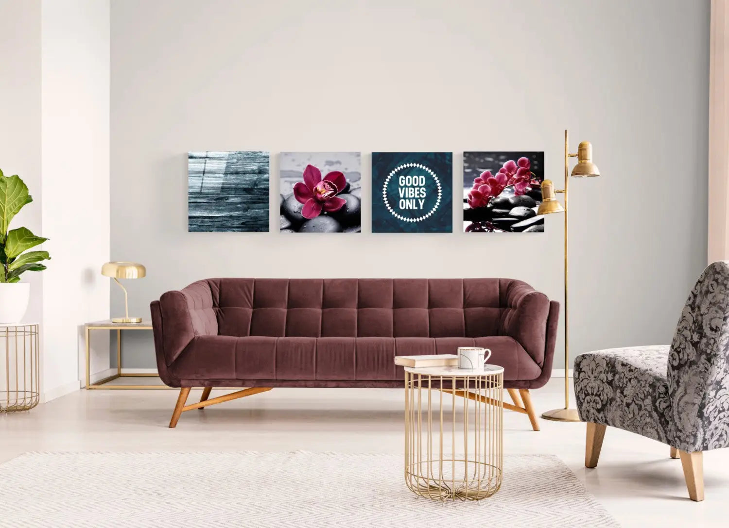 Plush burgundy velvet sofa with tufted upholstery and light wood legs, vibrant glass wall art set.