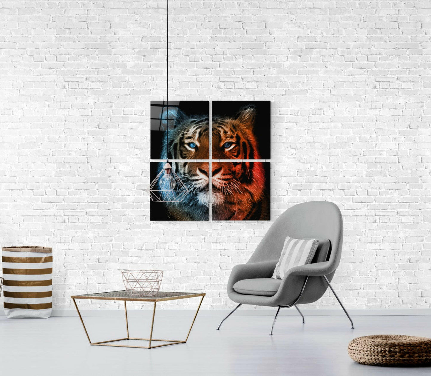 Four-panel glass tiger artwork mounted on white brick wall above gray chair, showing split tiger face in blue and orange tones.