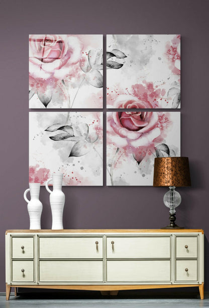 Four-panel glass wall art displaying pink roses and gray leaves with watercolor splashes, displayed above a cream dresser with white ceramic vases and a bronze lamp.