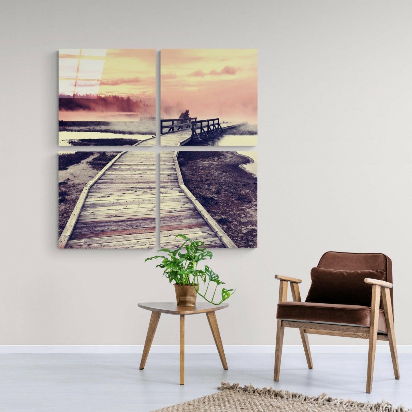 Four-panel glass wall art depicting wooden boardwalks extending through misty marshland at sunrise, displayed above mid-century modern furniture.