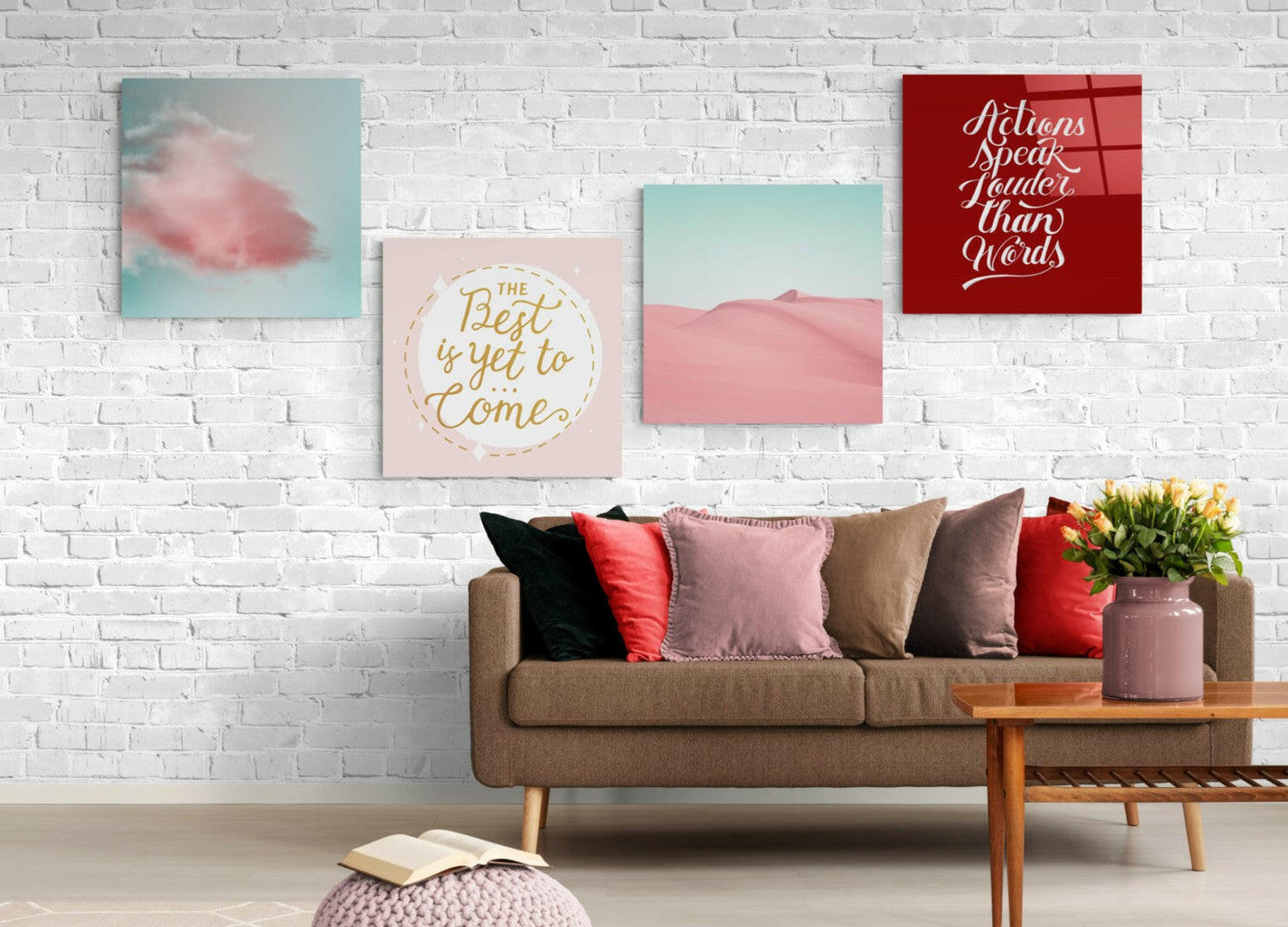 Turquoise and pink desert landscape glass wall art displayed above a tan sofa in a styled living room interior.