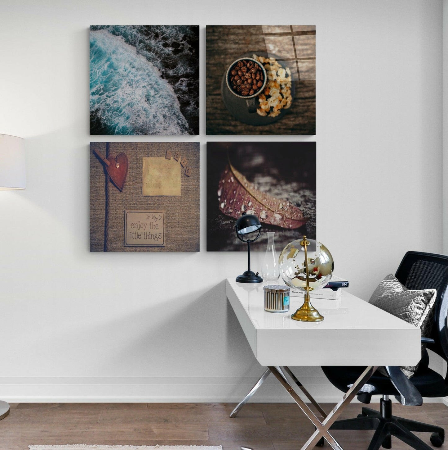 Four square glass wall art panels in 2x2 grid displaying ocean waves, food styling, heart with text, and leaf with water droplet above white desk.