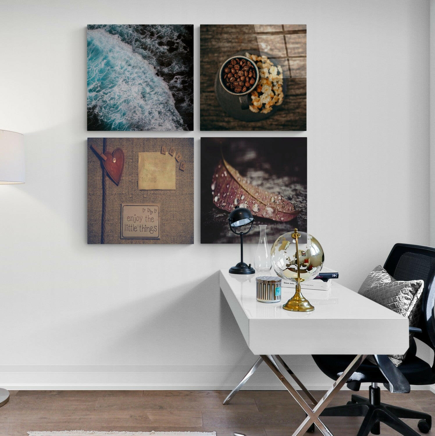 Four square glass wall art panels in 2x2 grid displaying ocean waves, food styling, heart with text, and leaf with water droplet above white desk.