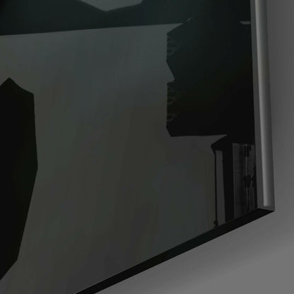 Close-up angled view of black silhouette artwork on translucent glass panel with white frame edge.