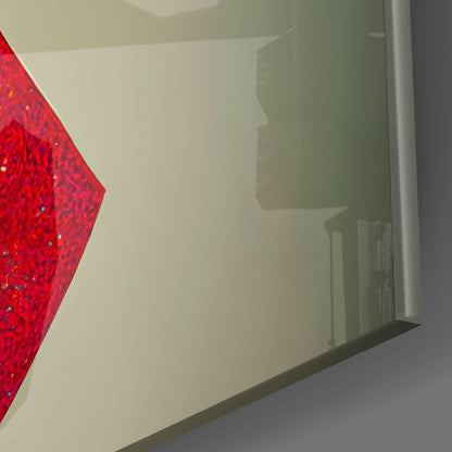 Close-up side view of red sparkly glass art panel mounted on white wall with shadow silhouette visible.