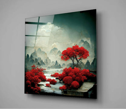 Glass wall art displaying a misty Asian landscape with vibrant red trees reflected in water, mounted at an angle against a gray wall.
