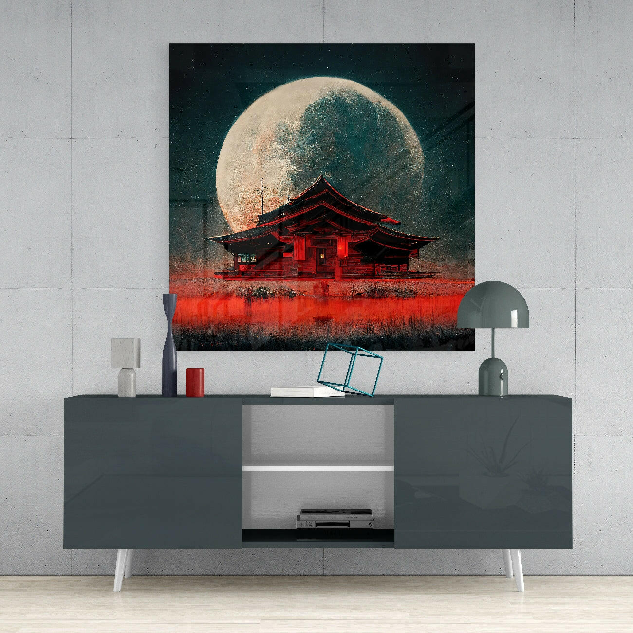 Red Asian temple silhouetted against enormous full moon with dark starry sky, displayed above gray media console.
