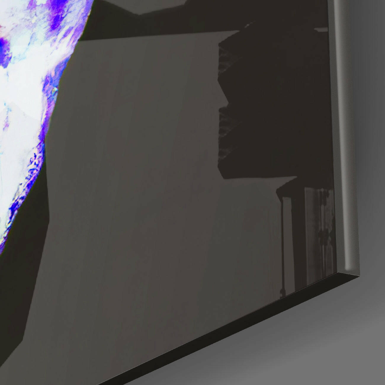Close-up angled view of glass wall art with purple and blue neon-style edge lighting against dark interior backdrop.