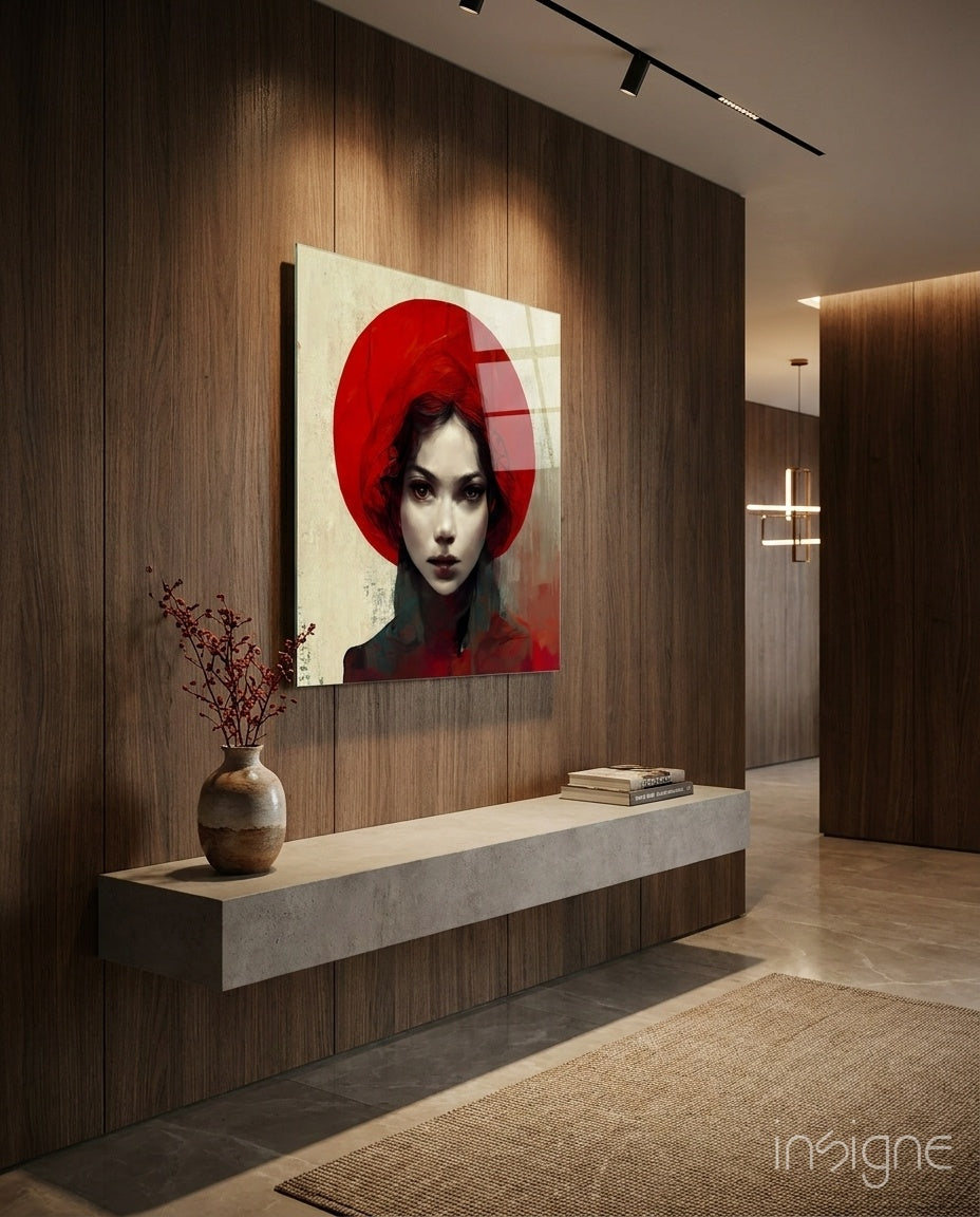 Modern interior hallway featuring a large glass wall art portrait of a woman in red headwear against cream background, mounted above a concrete console table.