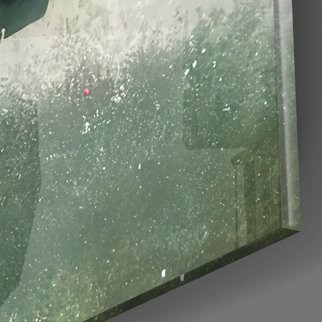 Aerial view of textured green glass wall art with white speckled pattern and a person in red jacket for scale.