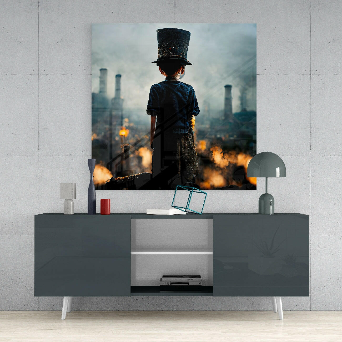 Child in top hat and blue shirt standing on industrial ruins with burning factory smokestacks in background, displayed as glass wall art above gray media console.