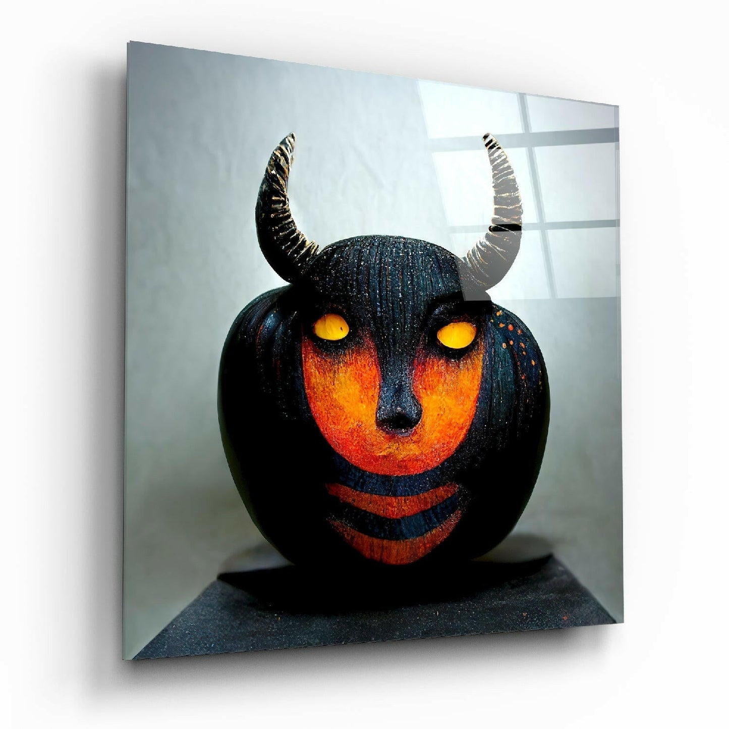 Black spherical pumpkin sculpture with glowing orange face, yellow eyes, and curved horns displayed on glass wall art against light background.