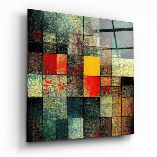 Abstract glass wall art with colorful mosaic squares in red, yellow, green, and brown tones arranged in grid pattern with textured surface detail.