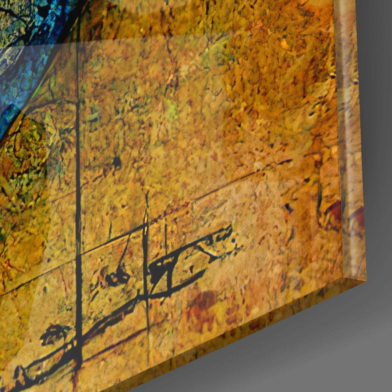 Close-up detail of textured yellow and orange glass surface with black botanical silhouettes and subtle reflections.