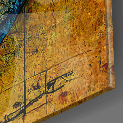 Close-up detail of textured yellow and orange glass surface with black botanical silhouettes and subtle reflections.
