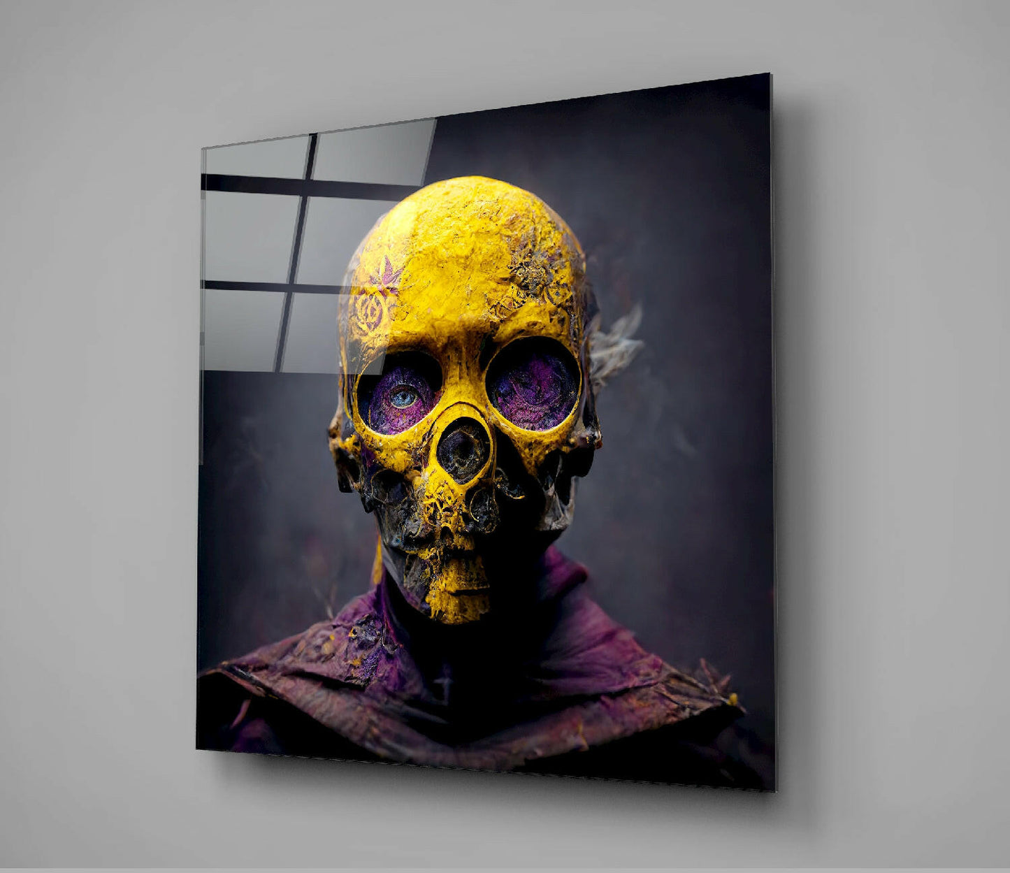 Yellow and black ornate skull with purple eyes mounted as glass wall art, angled view showing reflective surface and grid pattern.