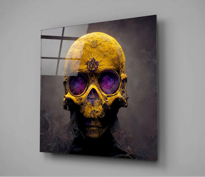 Gold skull with purple glowing eyes mounted on gray wall, showing front view of glass art piece.