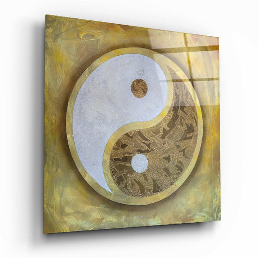 Square glass yin-yang wall art with gold leaf border, light blue and patterned brown halves, mounted on textured golden-yellow background.
