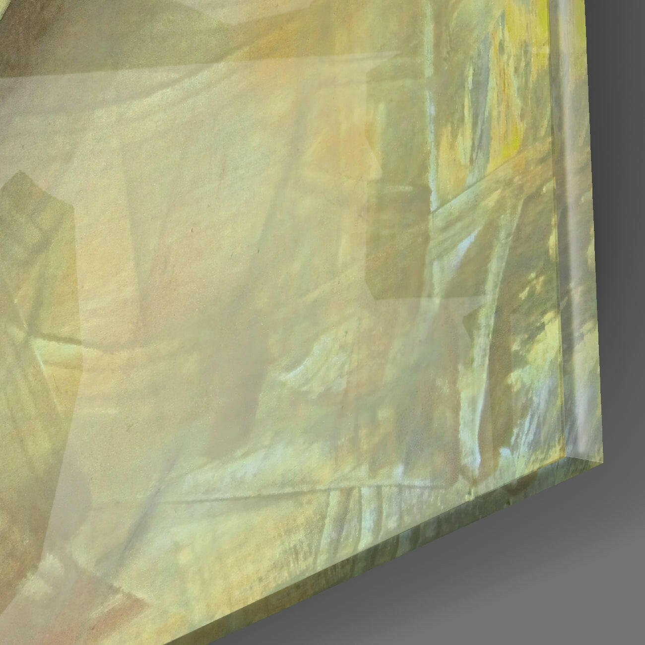 Close-up angled view of translucent yellow and cream glass panel showing layered texture and light refraction.
