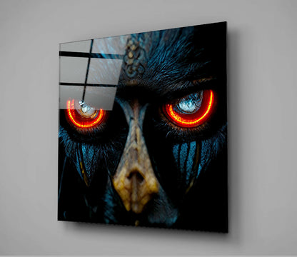 Black owl with glowing red-orange eyes mounted on gray wall, displayed at angled perspective showing glass panel construction.